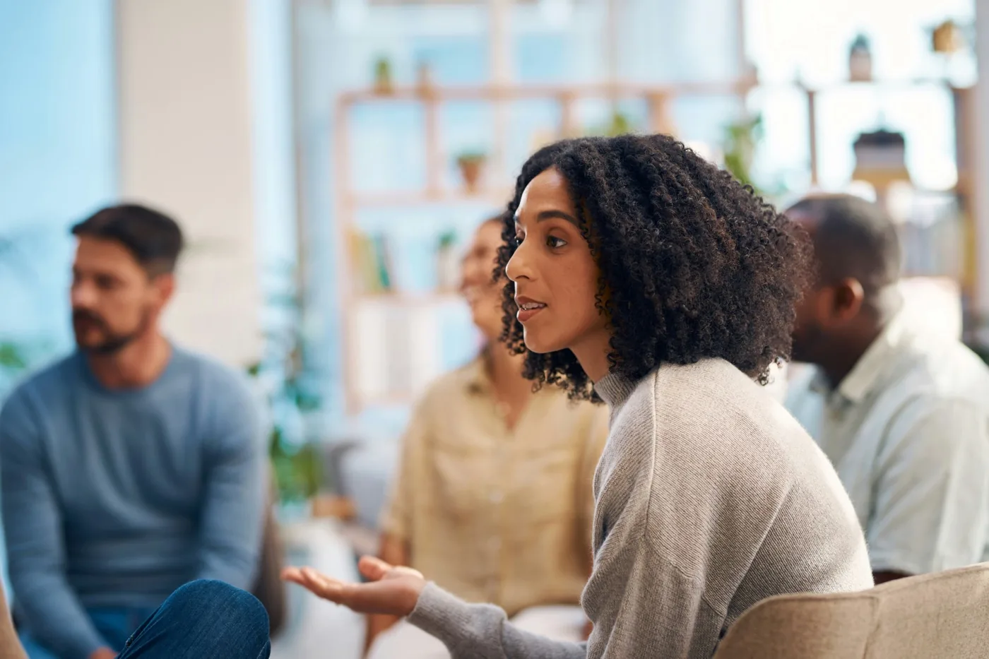 A woman speaking in a seated community discussion